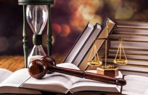 Gavel, scales of justice, hourglass and law books